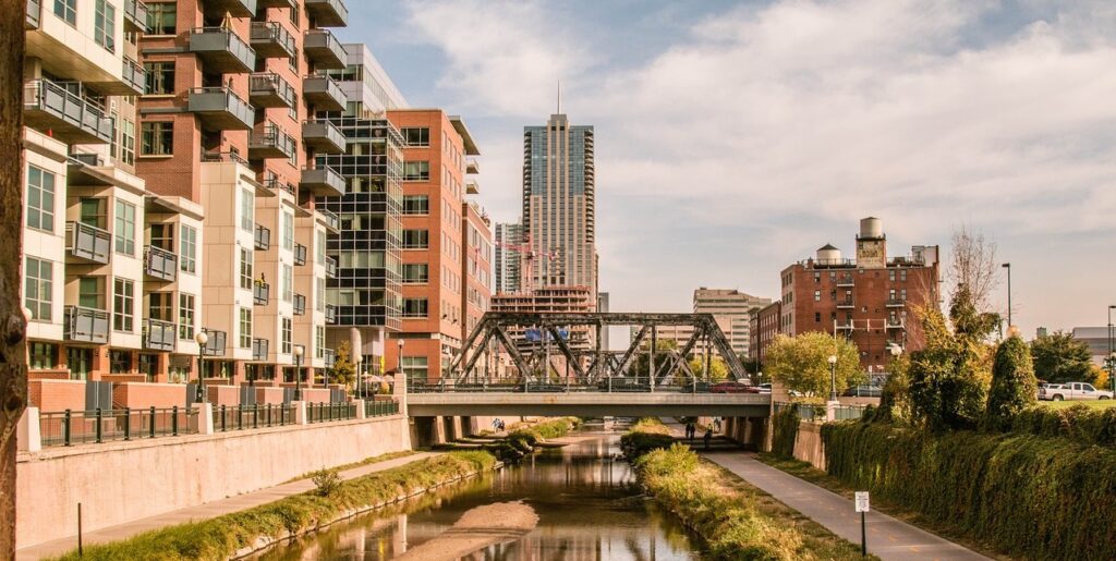 Downtown Denver with a picture of a river and a bridge over it